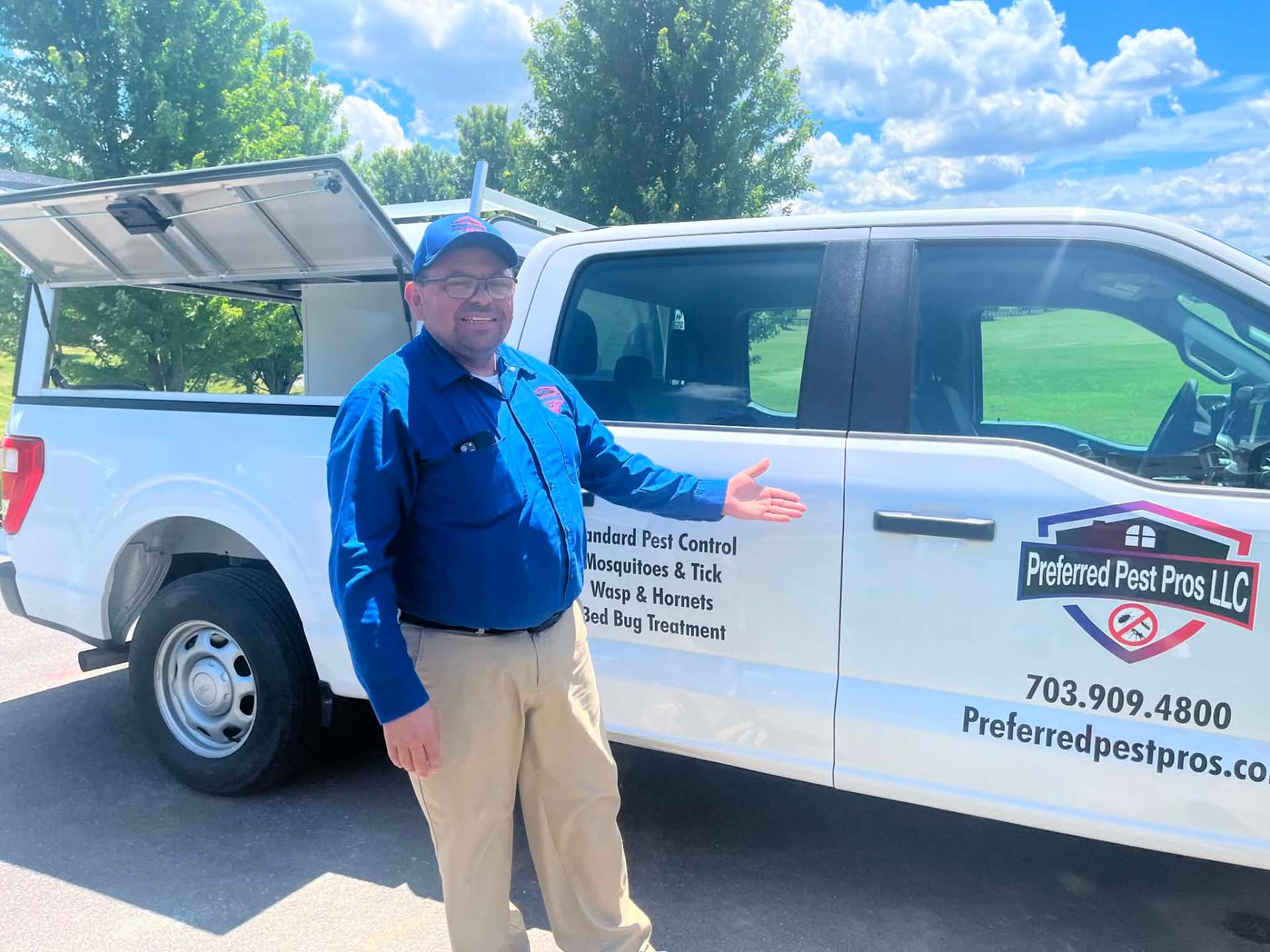 Preferred Pest Pros LLC owner standing beside branded company service truck in Northern Virginia